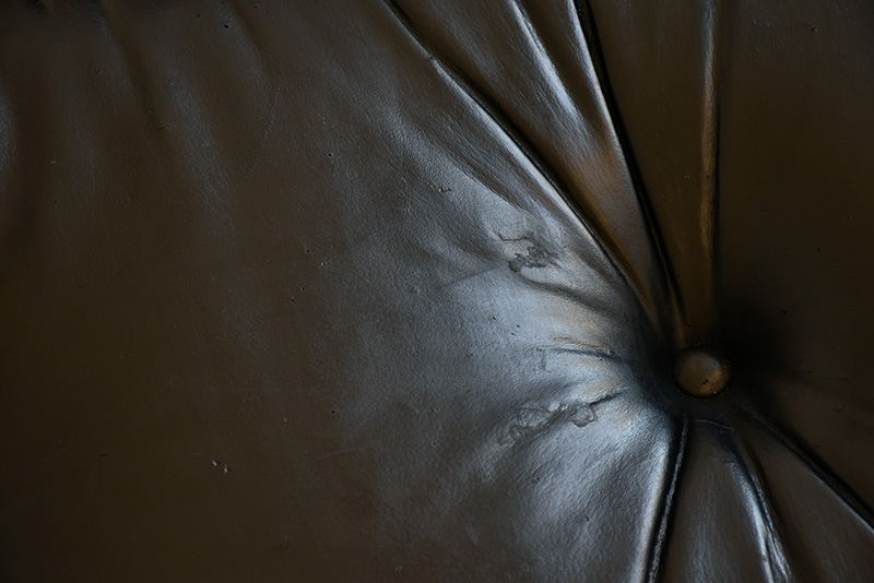 Detail repair on the ottoman's leather